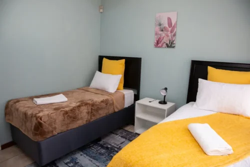Close view of two beds and the bedside table between them in the Deluxe Room.