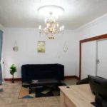 The lounge with a blue sofa and chandelier
