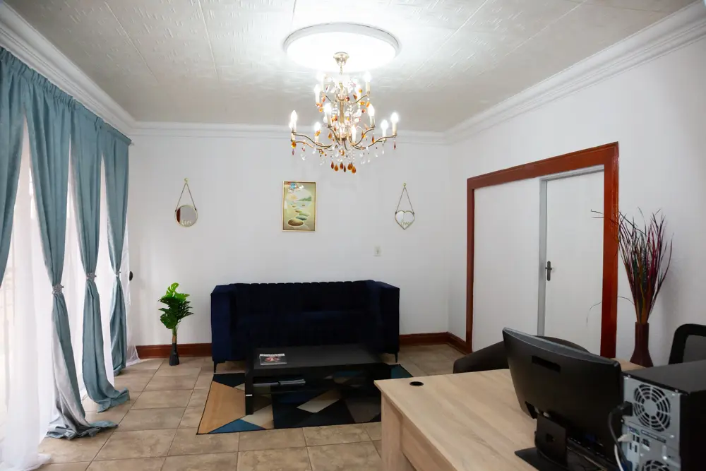 The lounge with a blue sofa and chandelier