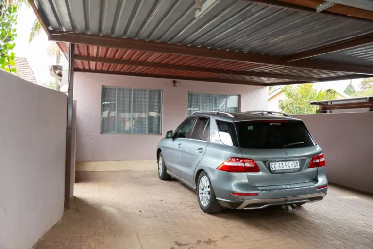 Covered carport parking inside the gate