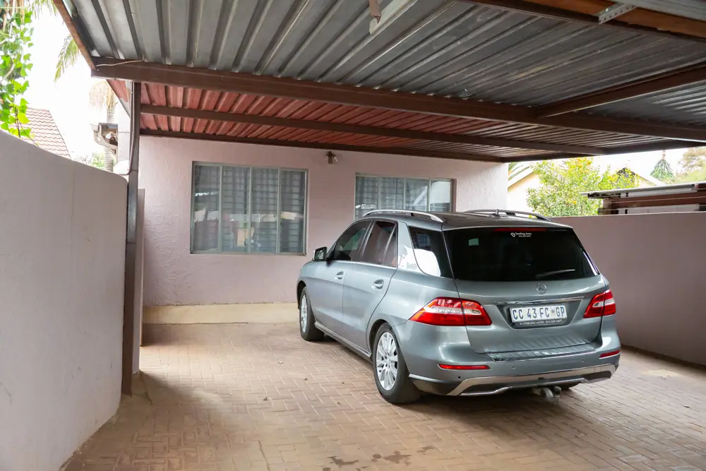Covered carport parking inside the gate